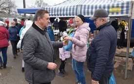 Wręczanie kobietom kwiatka i życzeń przez Burmistrza 