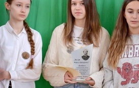3 dziewczyny trzymające w dłoniach dyplomy oraz statuetkę